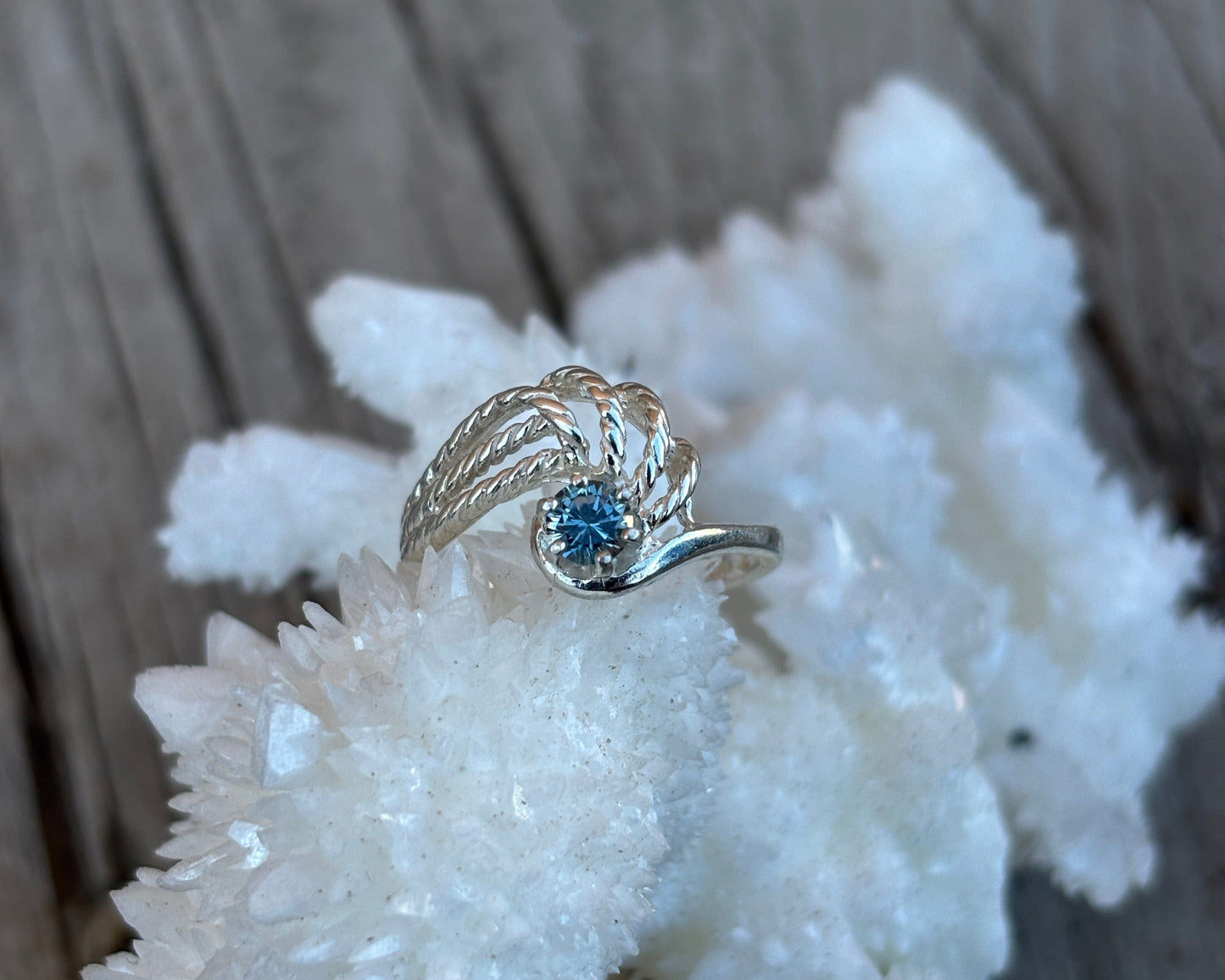 Sterling ring with a blue sapphire in a rope detailed band