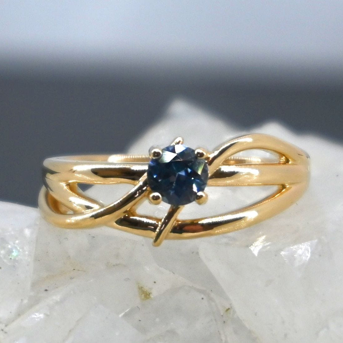 Sapphire criss cross ring with blue sapphire