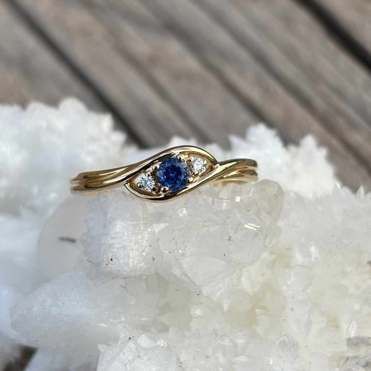 Gold ring with a blue Yogo sapphire and 2 diamond accents