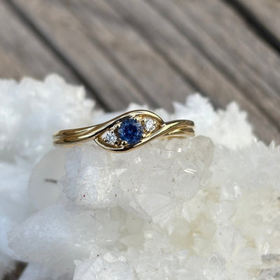Gold ring with a blue Yogo sapphire and 2 diamond accents