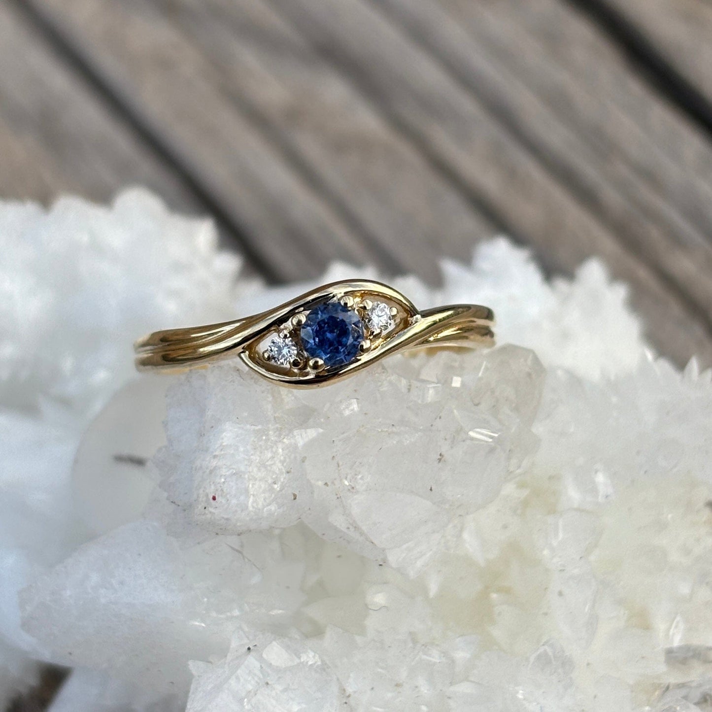 Gold ring with a blue Yogo sapphire and 2 diamond accents