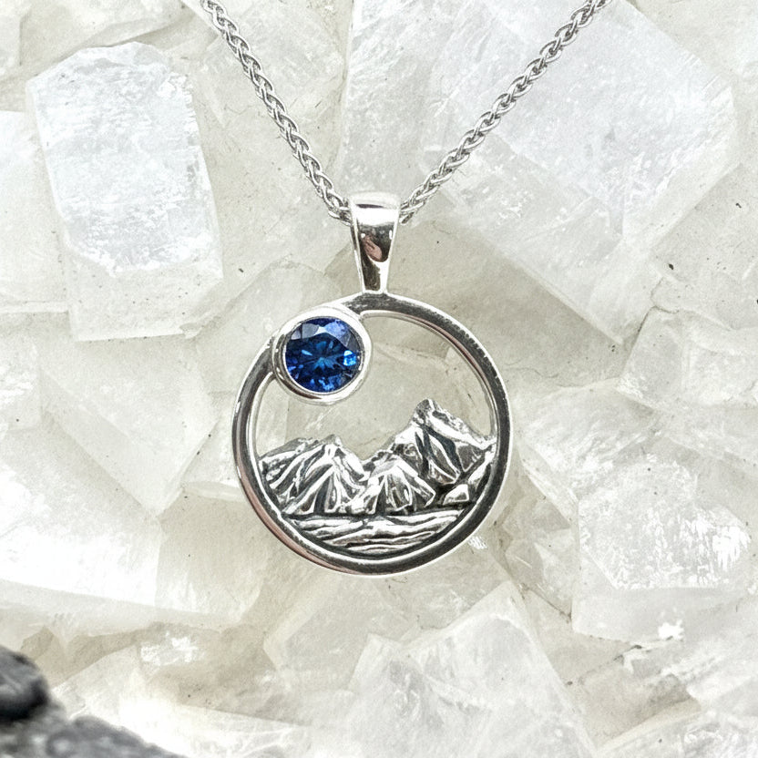 4mm Big Sky Sapphire Rustic round Mountain Pendant on crystal