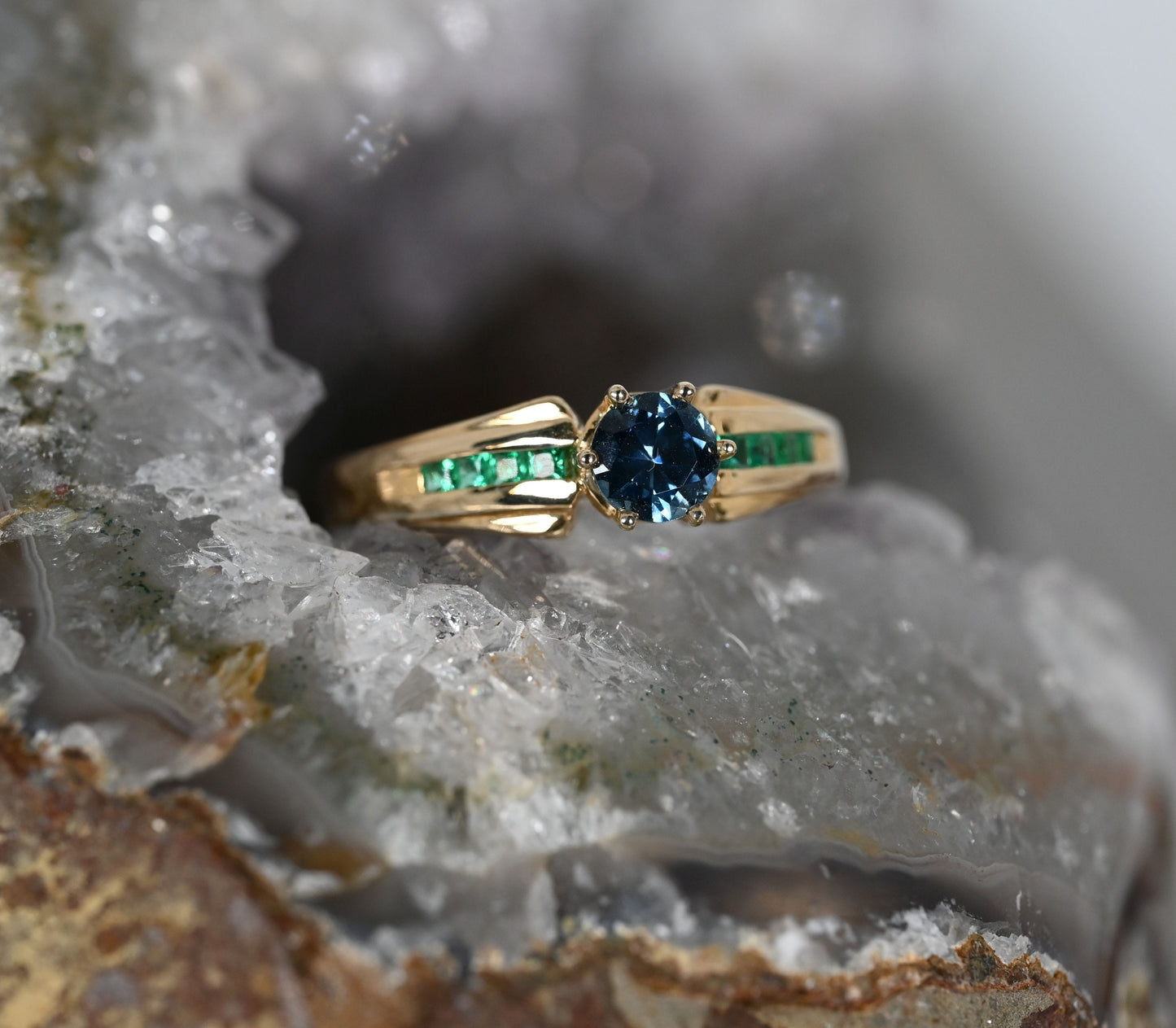 Blue Montana sapphire with princess cut  emerald accents in rich 14k yellow gold. 