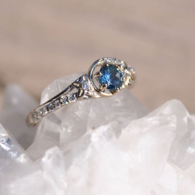 Engagement ring with blue Montana sapphires and flower accents 