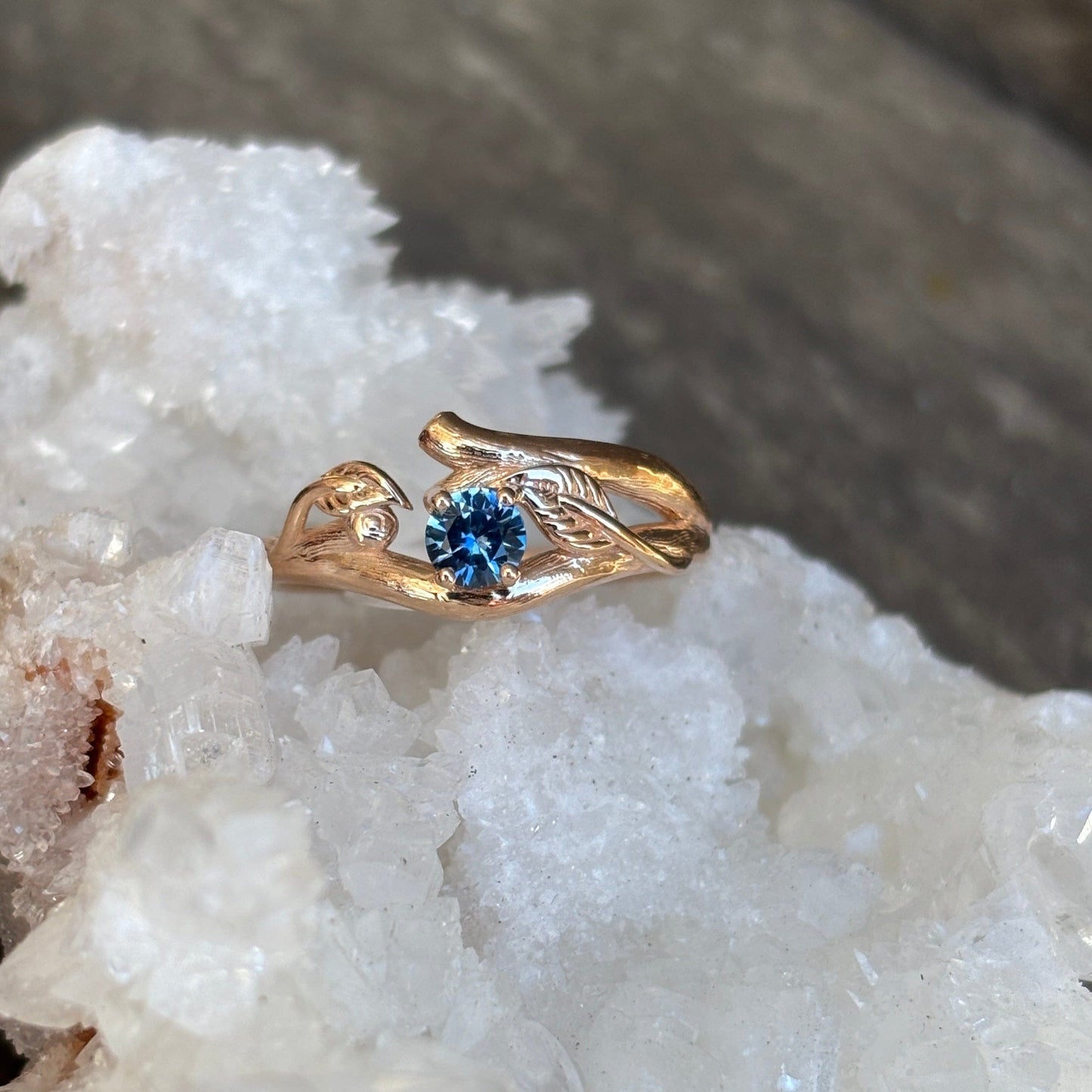 Gold ring with organic leaf accents and blue Montana sapphire gem 