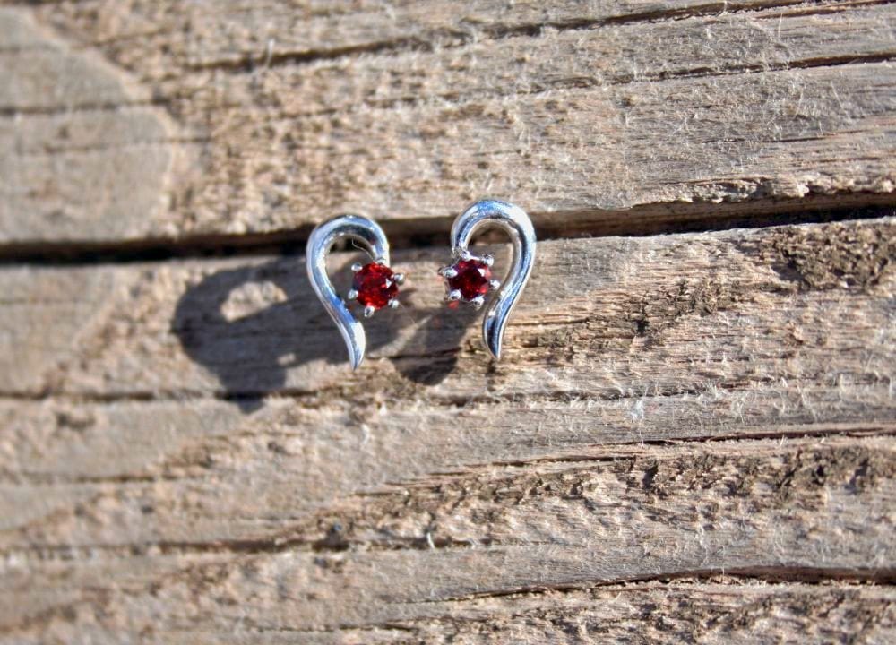 Silver earrings with red gem on wood, IMG_20171