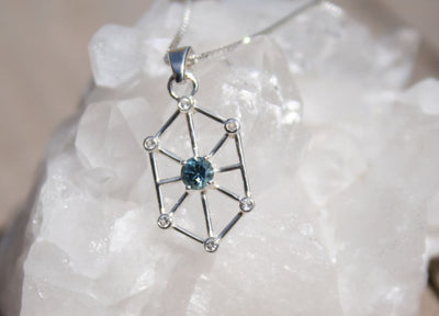 Geometric blue gemstone pendant on quartz crystal