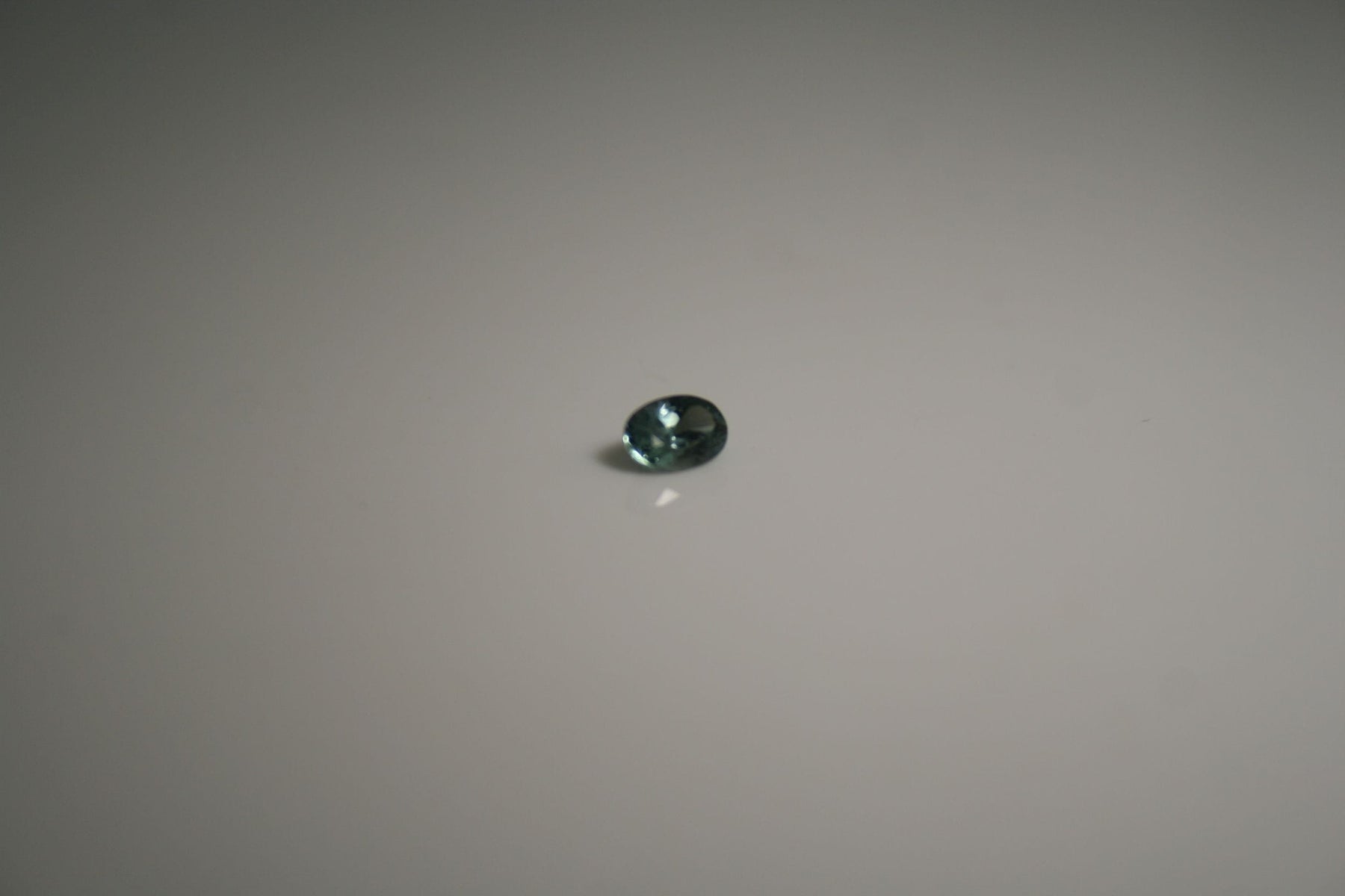 L911S Oval-cut teal gemstone