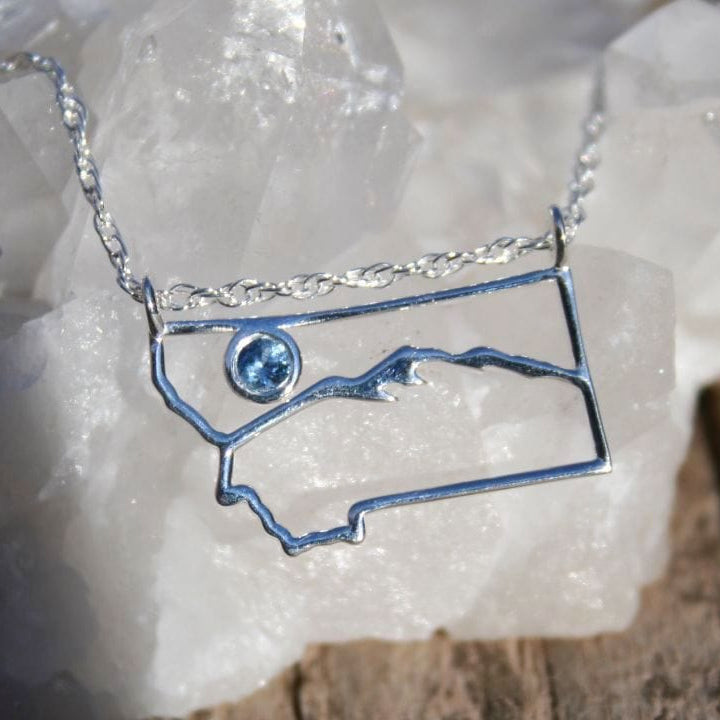 Montana outline necklace with mountain scene and blue Montana sapphire