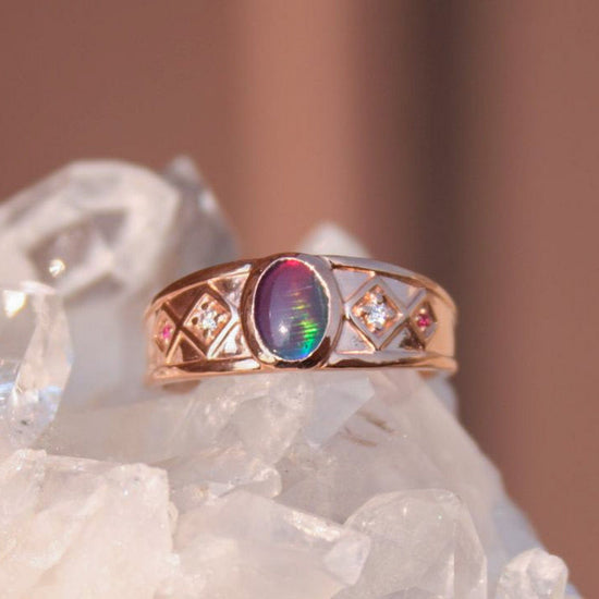 Rose gold ring with opal, rubies and diamonds.