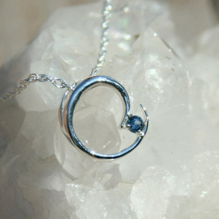 Silver circular pendant necklace with blue Montana sapphire 