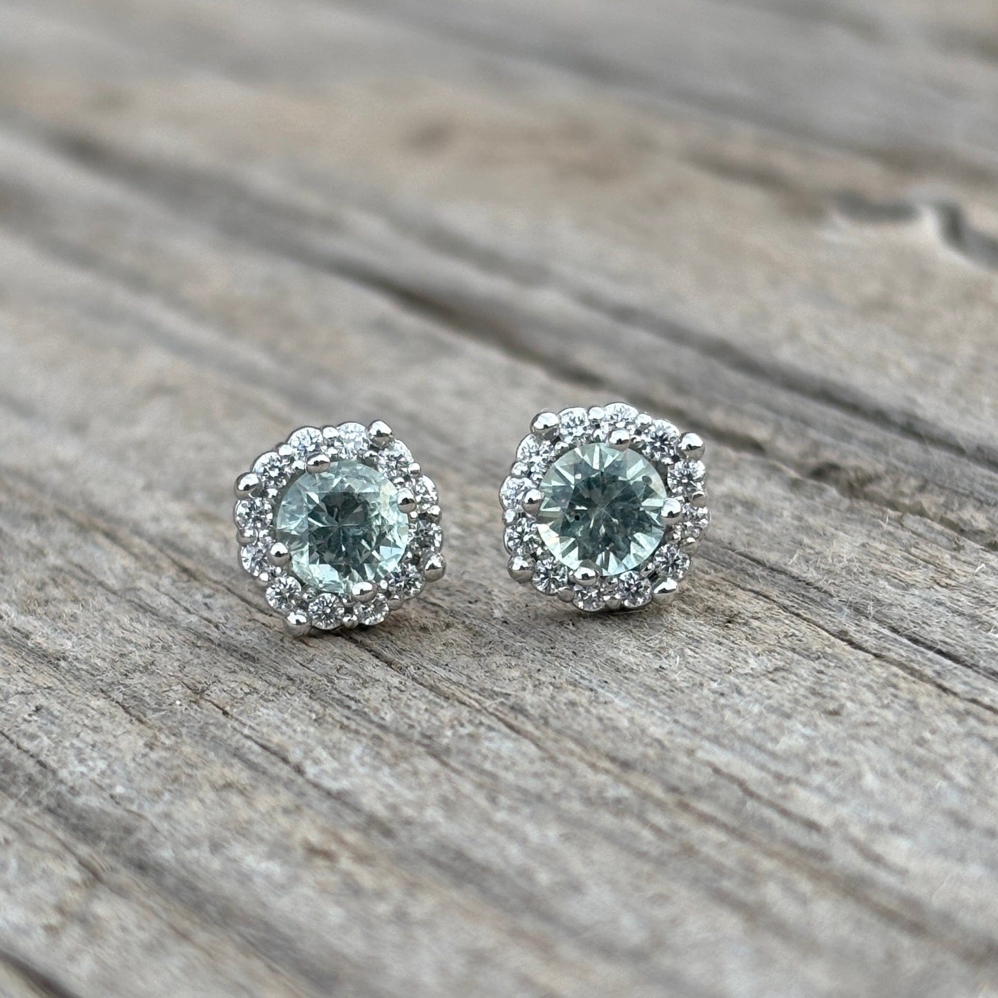Light green Montana sapphires with diamond halo stud earrings. 