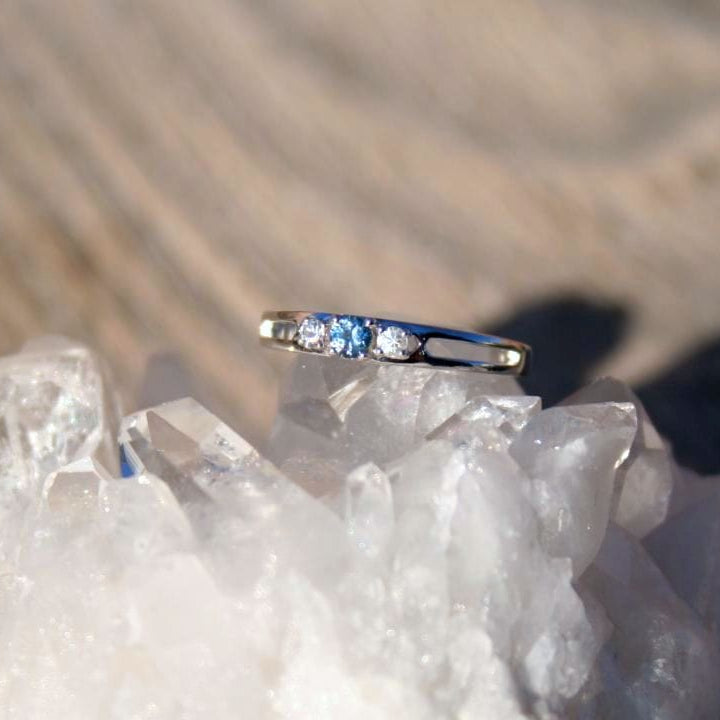 Montana Sapphire with white sapphire accents 3 stone ring on quartz crystal