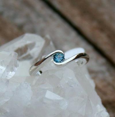 Classic bypass solitaire ring with partial bezel for great security while allowing plenty of light. 