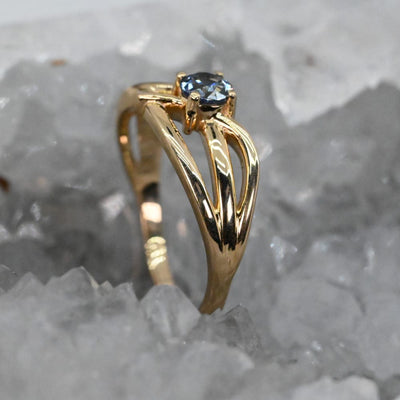 Gold open weave ring with a blue sapphire