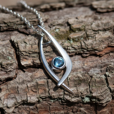 Silver pendant with blue Montana sapphire in modern design 