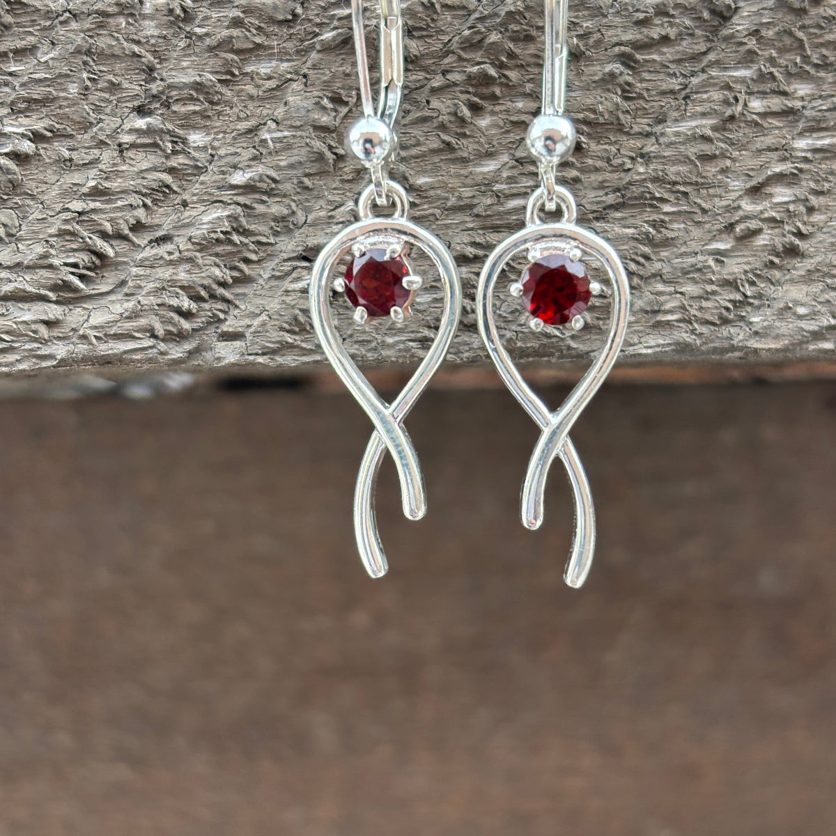 Silver earrings with wrapped style with red garnets