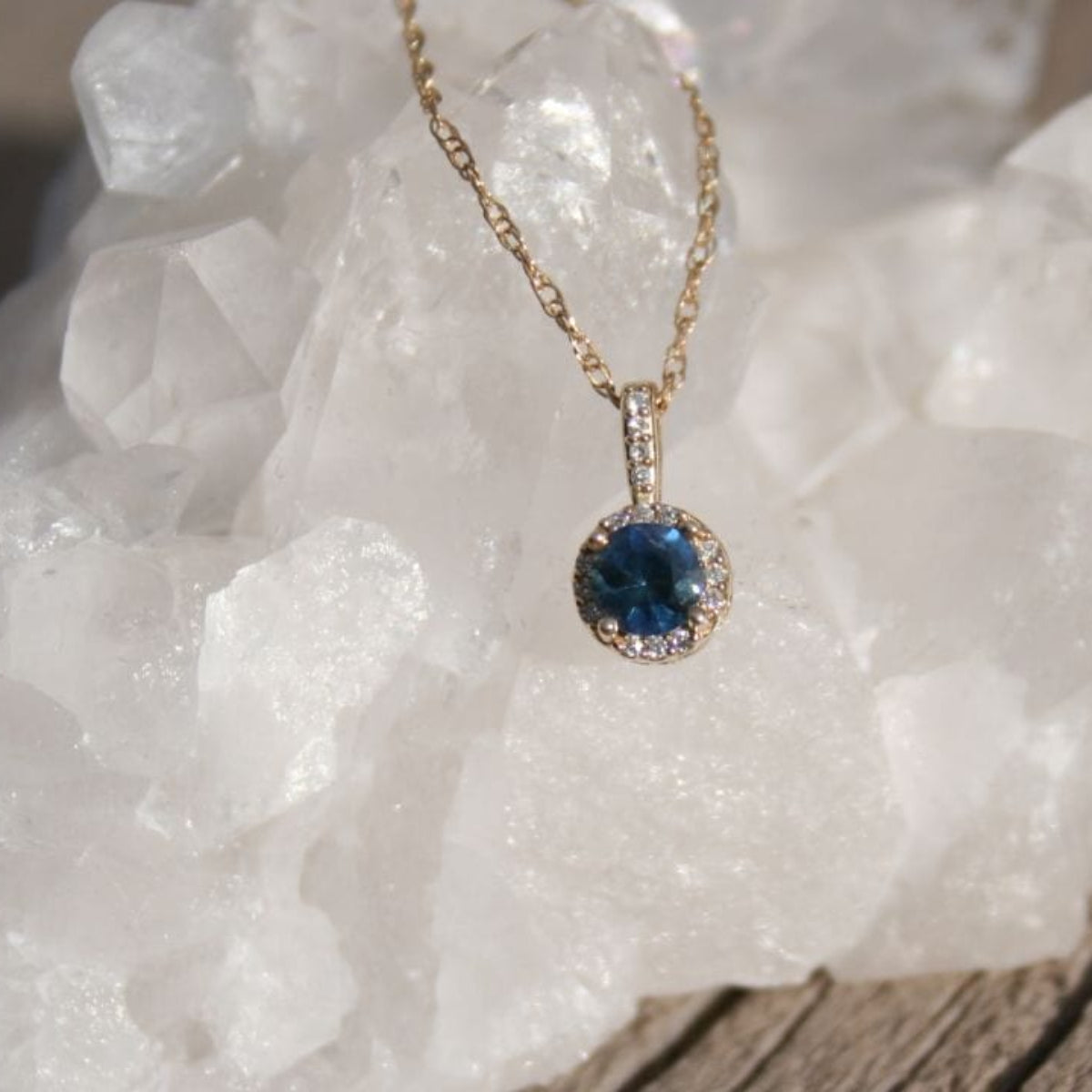 Blue Montana sapphire with diamond halo pendant