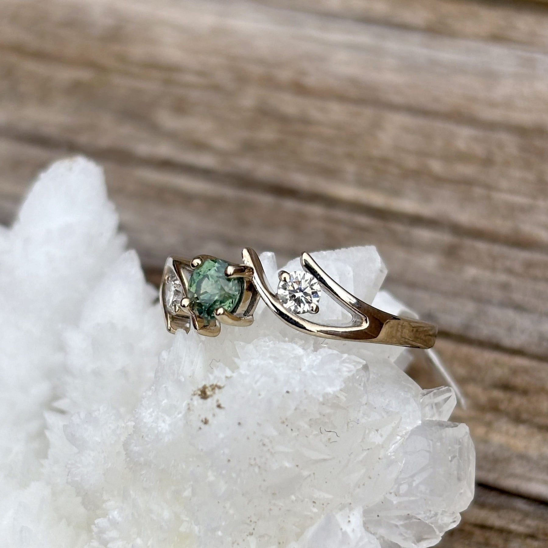 Montana Gems and Sapphire Jewelry white gold bypass ring featuring a green Montana sapphire and two side diamonds.