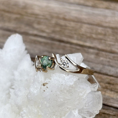 Montana Gems and Sapphire Jewelry white gold bypass ring featuring a green Montana sapphire and two side diamonds.