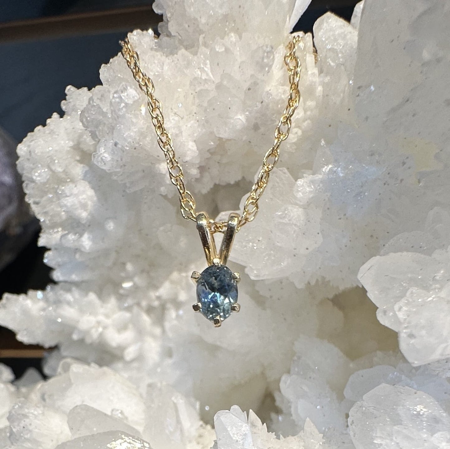 Montana Gems and Sapphire Jewelry icy blue Montana sapphire pendant in 14k yellow gold with a six-prong setting.