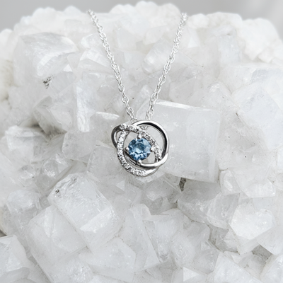 Infinity halo Montana sapphire accented sterling pendant