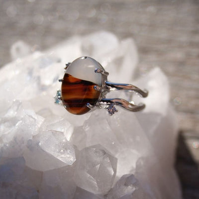 Montana agate ring with natural tones and sapphire accents