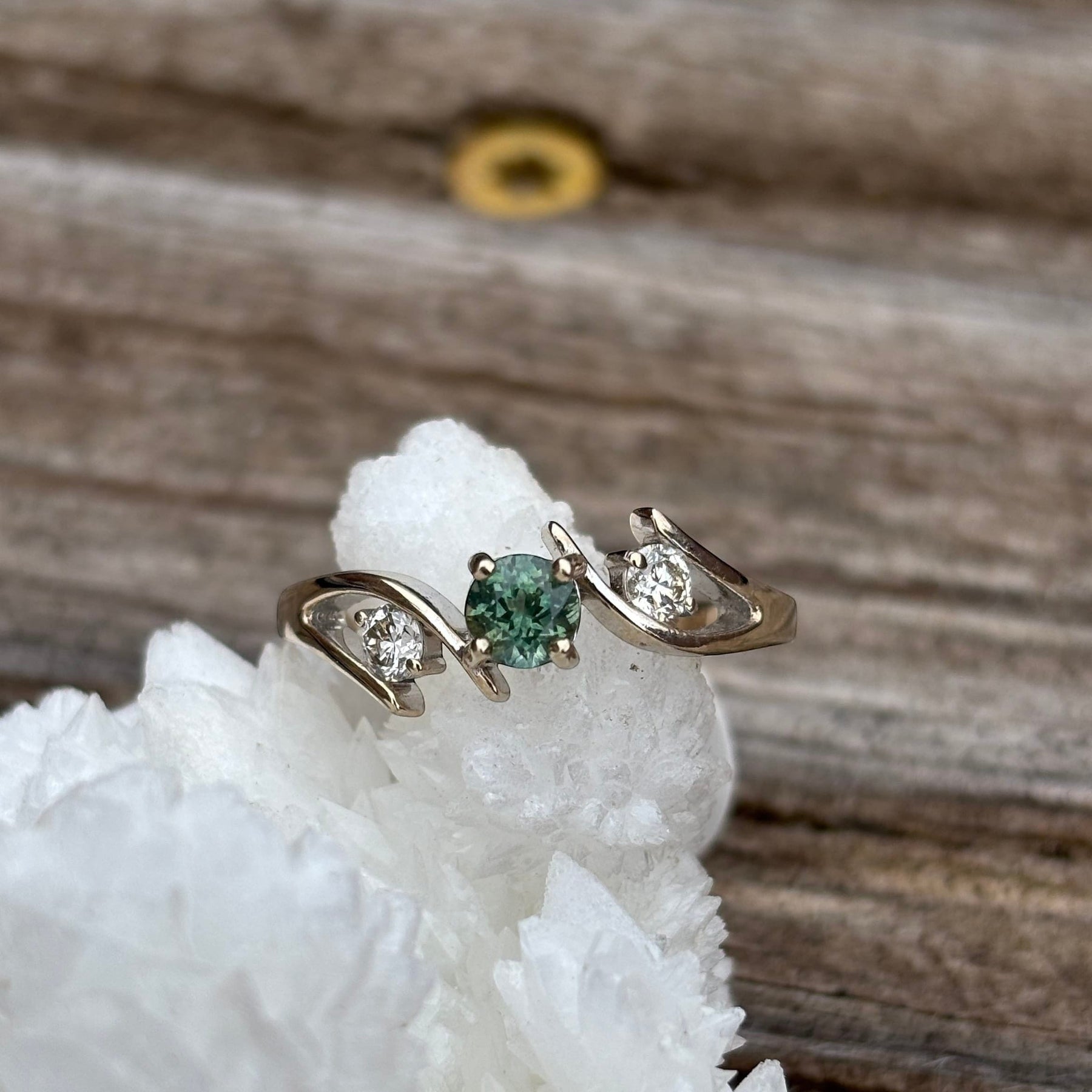 Montana Gems and Sapphire Jewelry white gold bypass ring featuring a round green sapphire and two side diamonds.