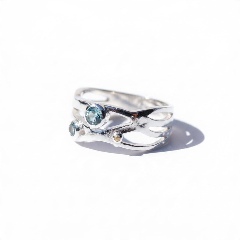 Montana Gems and Sapphire Jewelry organic sterling silver ring with three bezel-set sapphires and a wide band.