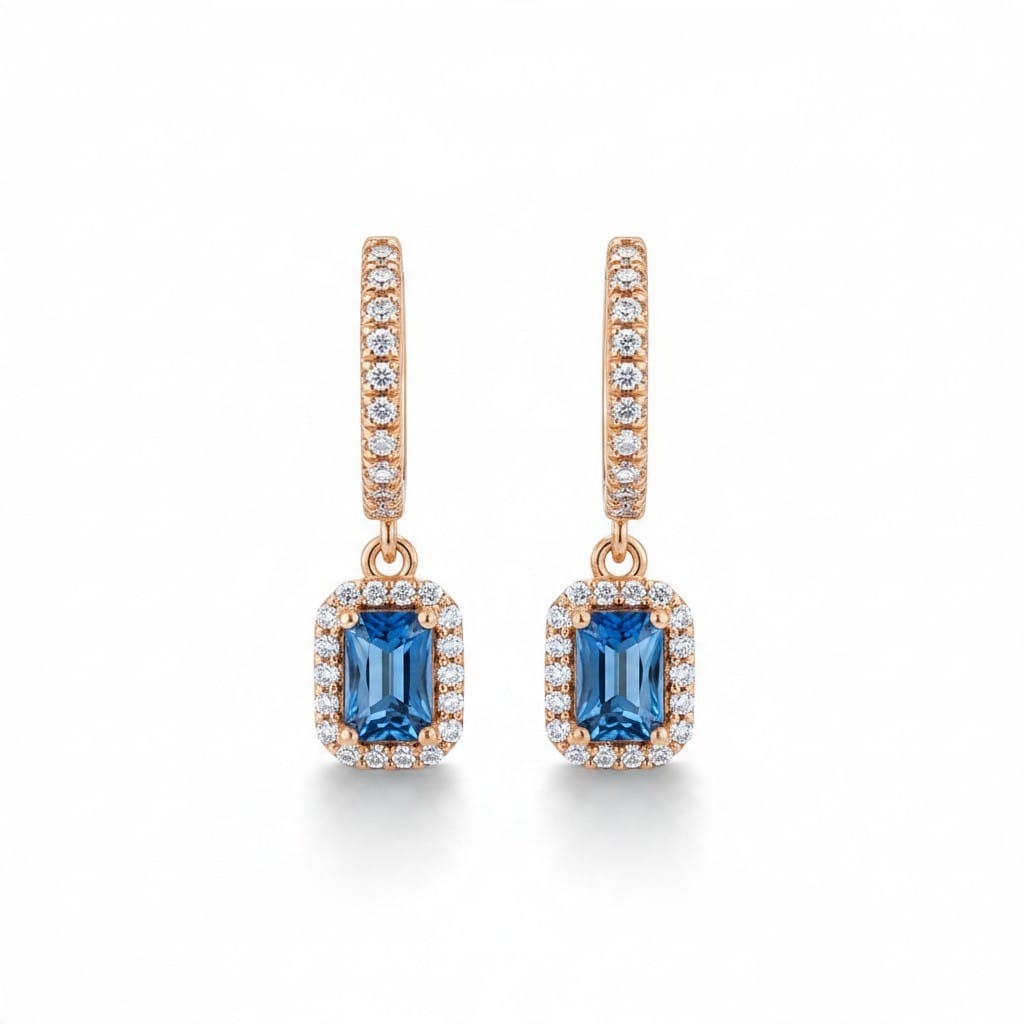 Montana Gems and Sapphire Jewelry emerald cut blue sapphire halo dangle earrings in 14k yellow gold with diamonds.