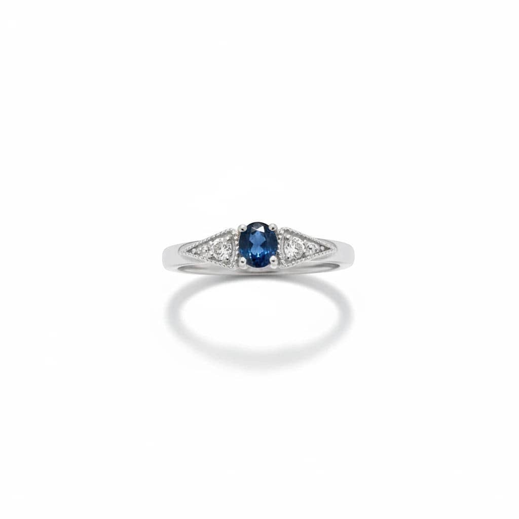 Montana Gems and Sapphire Jewelry sterling silver ring with a central blue Montana sapphire and two white side sapphires.