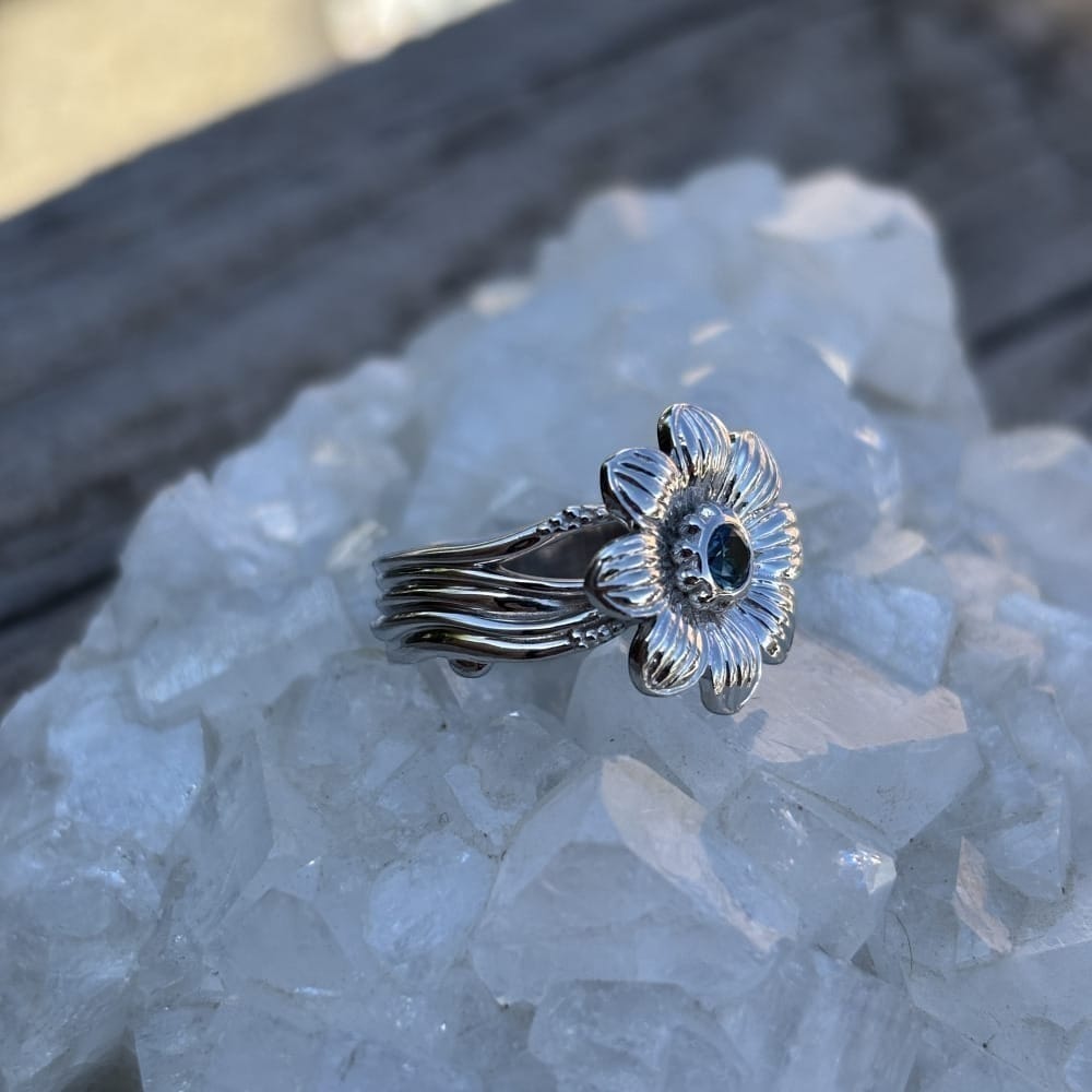 Montana Gems and Sapphire Jewelry sterling silver wildflower ring with a central blue sapphire on a quartz base.