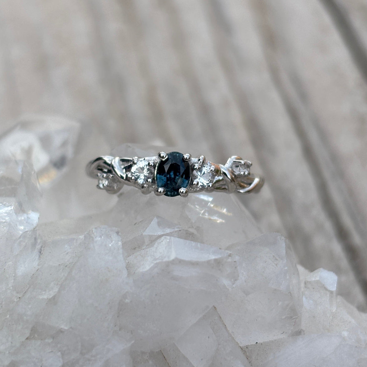 Silver barbed wire inspired ring with a blue sapphire and white sapphire accents