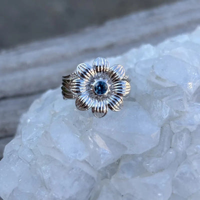 Montana Gems and Sapphire Jewelry sterling silver flower ring with a central blue Montana sapphire on quartz crystal.