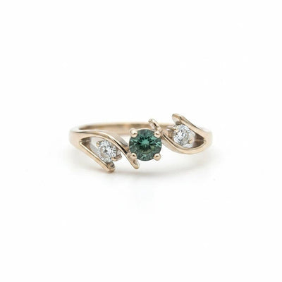 Montana Gems and Sapphire Jewelry bypass ring featuring a green Montana sapphire flanked by two diamonds in white gold.