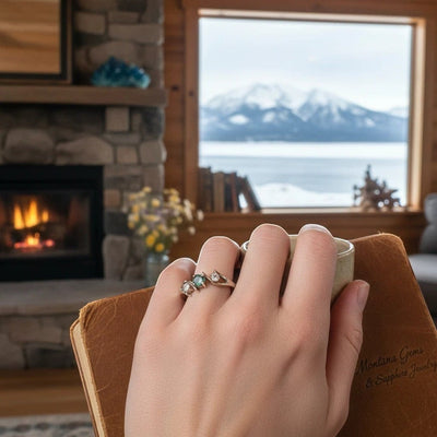 Montana Gems and Sapphire Jewelry white gold bypass ring with a green Montana sapphire and side diamonds on a hand
