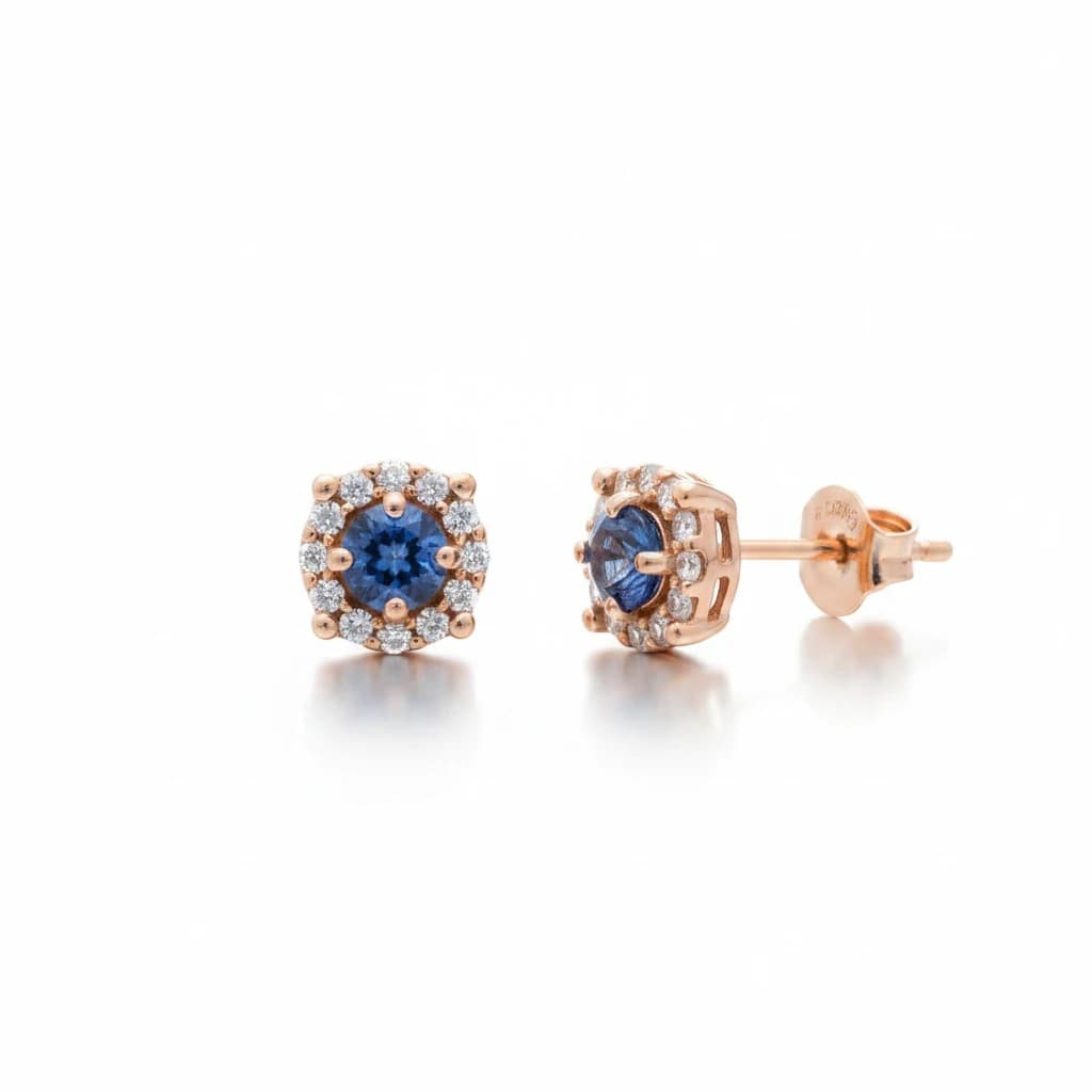 Montana Gems and Sapphire Jewelry Yogo sapphire stud earrings with a diamond halo set in 14k rose gold.