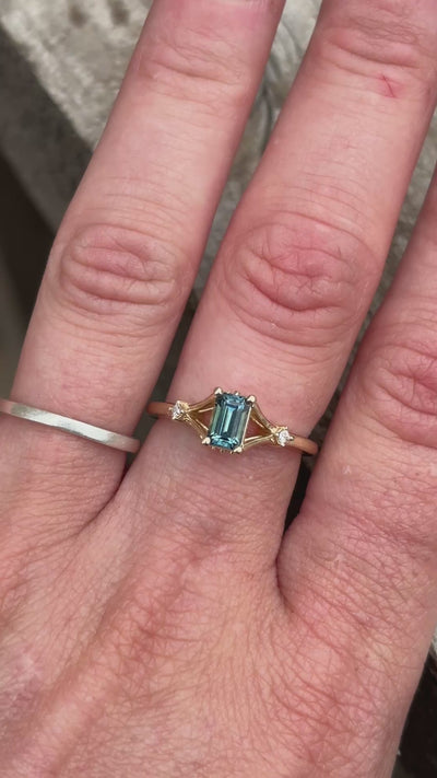Video of teal emerald cut Montana sapphire ring with princess cut diamond accents