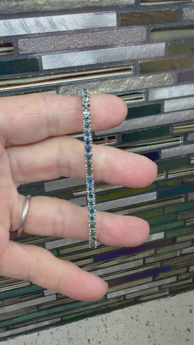 14k white tennis bracelet with 49 Montana sapphires in rich blue and teal. 