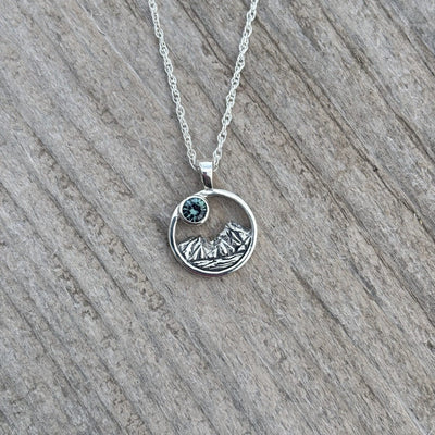 Rustic mountain scene sapphire pendant
