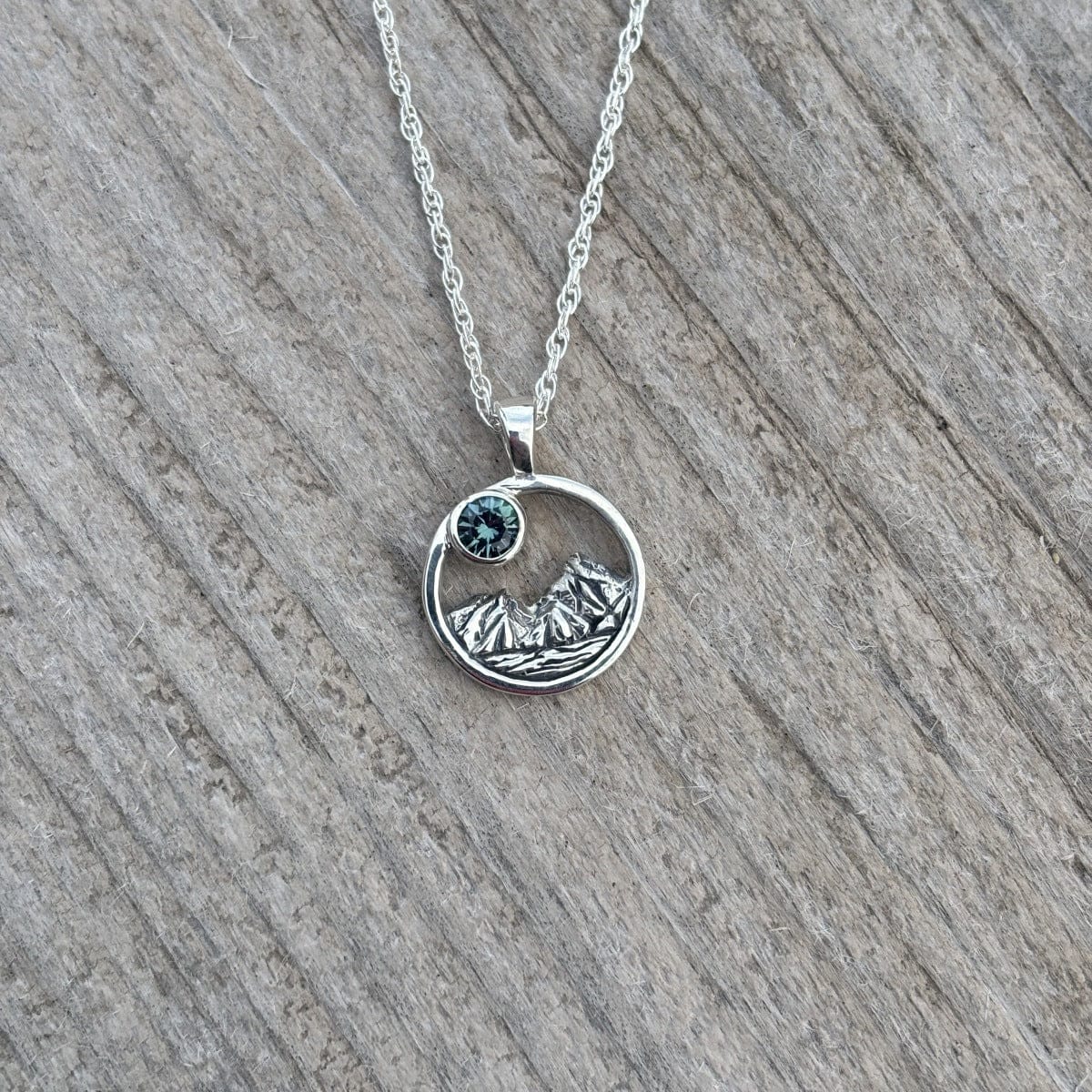 Rustic mountain scene sapphire pendant