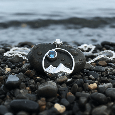 dainty mountain pendant on a rocky shore