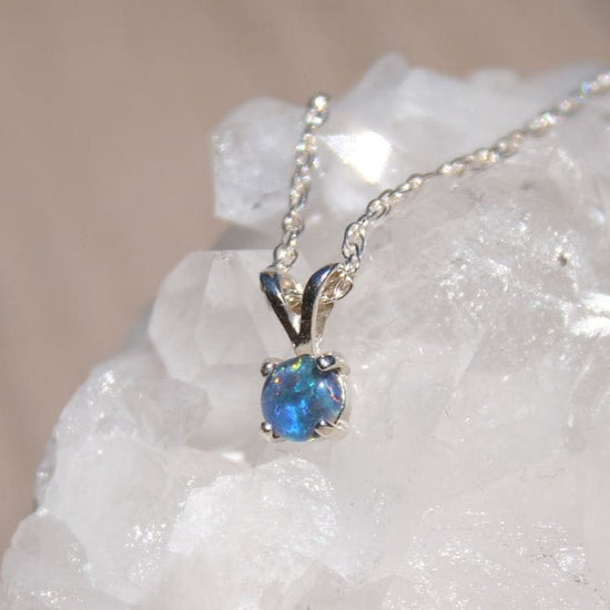 Opal necklace on a white crystal background