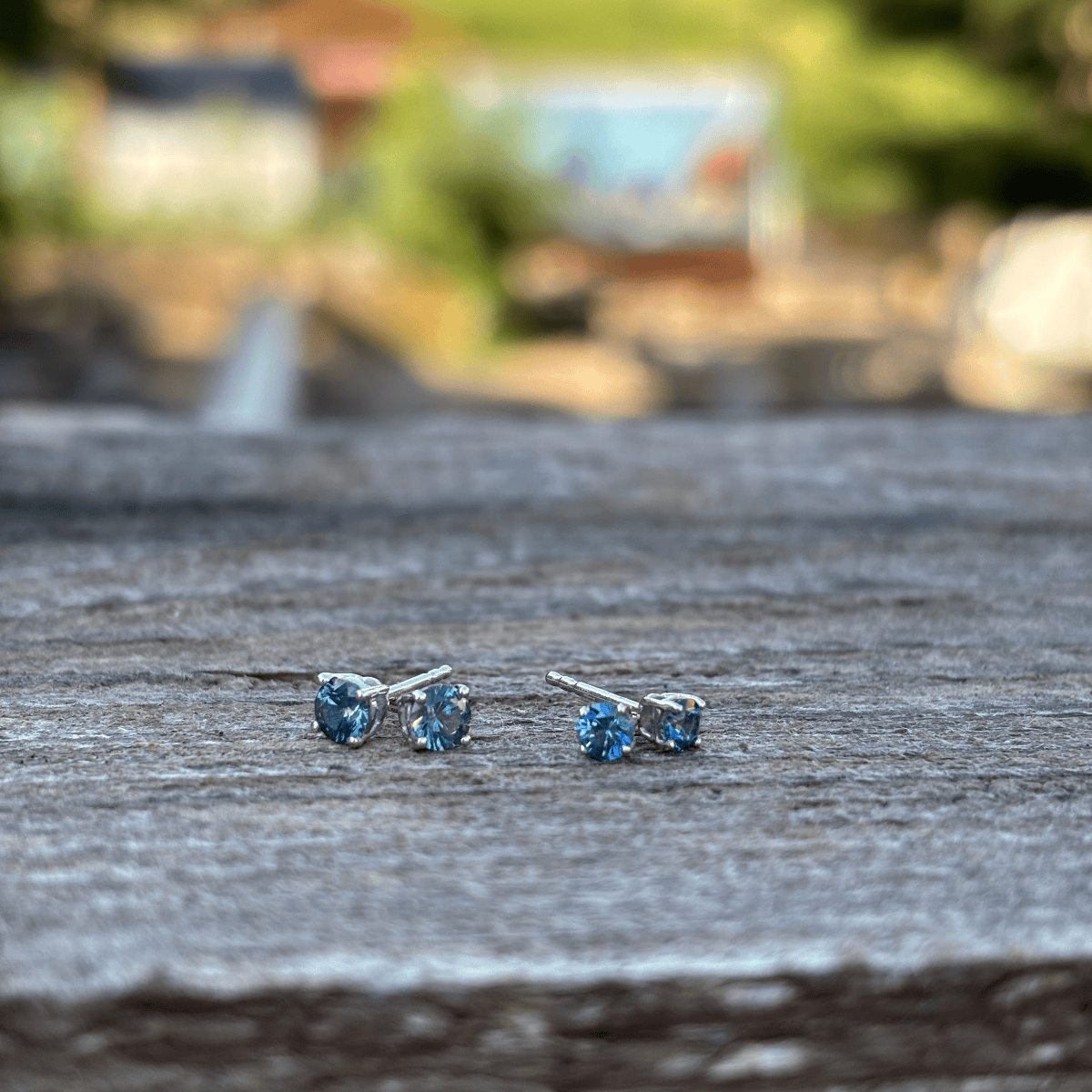 A pair of small stud earrings with round blue Montana sapphires set in sterling silver with butterfly backs.