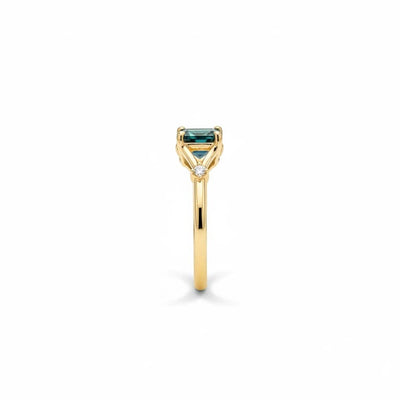 Montana Gems and Sapphire Jewelry teal emerald cut Montana sapphire ring in yellow gold with side diamond accents
