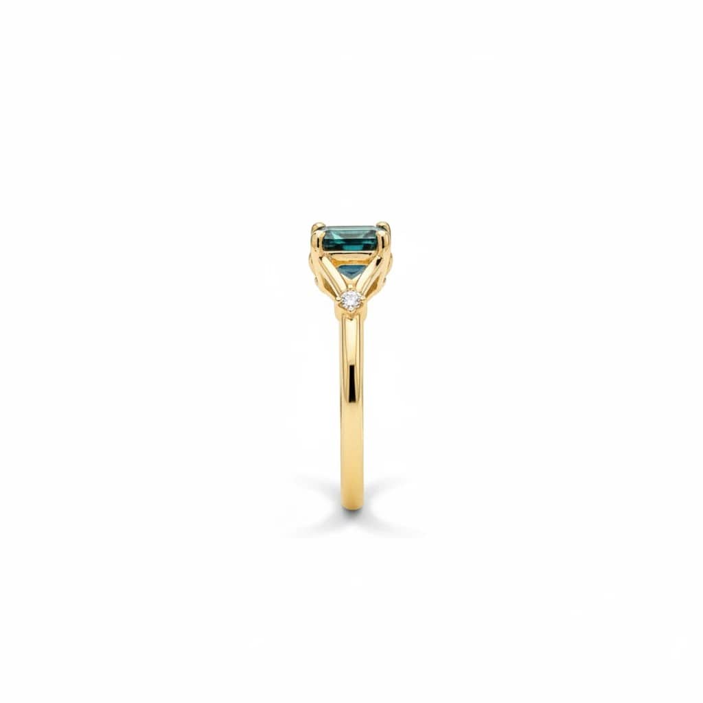 Montana Gems and Sapphire Jewelry teal emerald cut Montana sapphire ring in yellow gold with side diamond accents