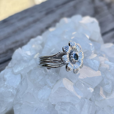 Montana Gems and Sapphire Jewelry sterling silver wildflower ring with a central blue sapphire on a quartz base.