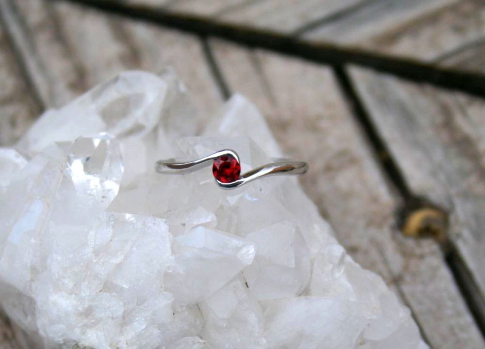 R307G Red gemstone ring on white quartz